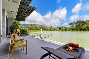 a patio with a view of a body of water at Samui Fishing Club and Resort in Na Mueang