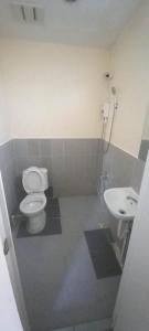 a bathroom with a toilet and a sink at Harang Hotel Mactan Lapulapu City Cebu Philippines in Maribago