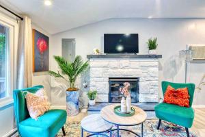 a living room with two chairs and a fireplace at Hot Tub Fire Pit Dog Friendly in Pocono Lake