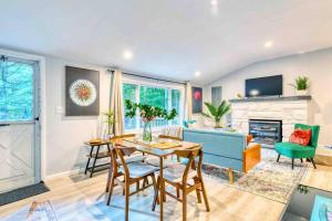 a living room with a blue couch and a table at Hot Tub Fire Pit Dog Friendly in Pocono Lake +27 photos