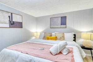 a bedroom with a large bed with a pink blanket at Hot Tub Fire Pit Dog Friendly in Pocono Lake