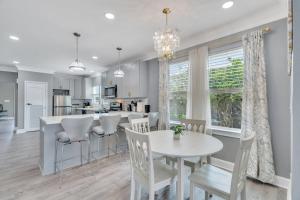 a kitchen and living room with a table and chairs at River Cottage near the Airport in Saint Rose