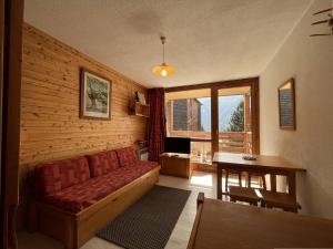 a living room with a couch and a table at Appartement Peisey-Nancroix-Plan Peisey, 1 pièce, 4 personnes - FR-1-757-79 in Peisey-Nancroix