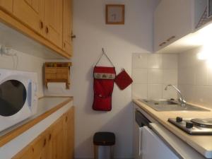 a kitchen with a sink and a towel hanging on the wall at Appartement Peisey-Vallandry, 2 pièces, 5 personnes - FR-1-757-80 in Landry