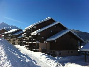 a building covered in snow with snow covered roofs at Appartement Peisey-Vallandry, 2 pièces, 5 personnes - FR-1-757-80 in Landry