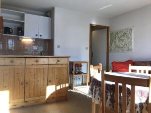 a kitchen with a wooden cabinet and a bed in a room at Appartement Peisey-Vallandry, 2 pièces, 4 personnes - FR-1-757-85 in Landry