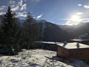 a building in the snow with mountains in the background at Chalet Peisey-Nancroix-Plan Peisey, 6 pièces, 11 personnes - FR-1-757-78 in Peisey-Nancroix