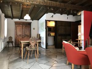 a living room with a table and red chairs at Chalet Peisey-Nancroix-Plan Peisey, 6 pièces, 11 personnes - FR-1-757-78 in Peisey-Nancroix