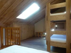 a bedroom with two bunk beds and a skylight at Appartement Peisey-Vallandry, 2 pièces, 6 personnes - FR-1-757-83 in Landry