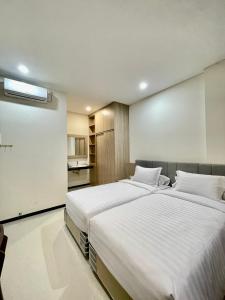 Un pat sau paturi într-o cameră la Kawa Living