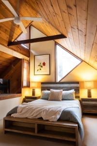 a bedroom with a large bed with a wooden ceiling at Lake Russell Retreat in Emerald Beach
