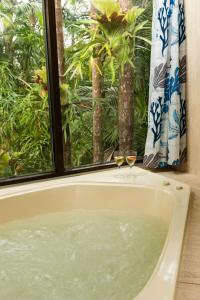 bañera con 2 copas de vino en Lake Russell Retreat, en Emerald Beach