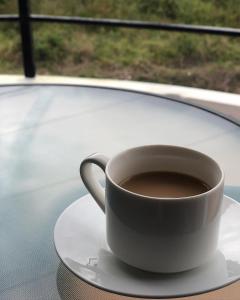a cup of coffee sitting on a table at Hotel Boutique Los Pinos in Santa Rosa de Copán