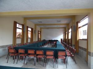 a long room with a long table and chairs at Hotel Los andes Suite Cajamarca in Cajamarca