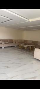 an empty room with couches and tables in it at شاليه تريك in Buraydah