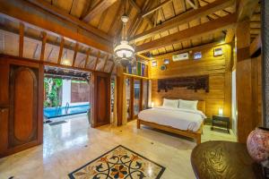 una camera da letto con un letto in una stanza con pareti in legno di Villa Arumanis a Canggu Altre 18 foto