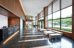 a lobby of a building with benches and windows at Hotel Interciti in Daejeon