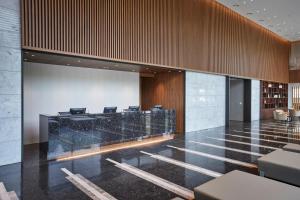 a lobby with a reception desk and chairs at Hotel Interciti in Daejeon