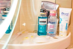 a shelf with three bottles of products on it at Cupid Hotel 2 in Ho Chi Minh City