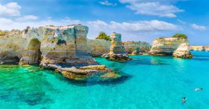 a view of the ocean with rocks in the water at "Il Vecchio Salone" appartamento in pieno centro con garage privato in Lecce
