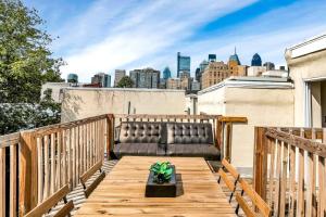 a couch on a balcony with a view of the city at Lovely 1br Apartment In Rittenhouse Square in Philadelphia