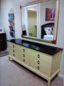 a yellow dresser with a mirror on top of it at Arden Park Charm in Sacramento