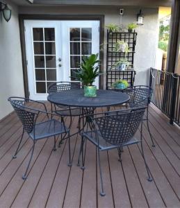 a patio table and chairs on a deck at Arden Park Charm in Sacramento