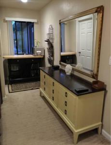 a bathroom with a large mirror and a dresser at Arden Park Charm in Sacramento