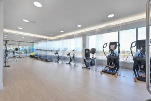 a gym with treadmills and ellipticals in a building at Central Sq 2BR w Gym WD Doorman nr T BOS-316 in Cambridge