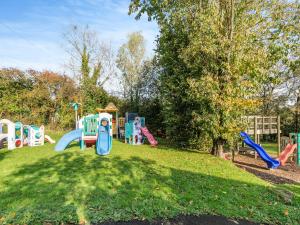 a playground with a bunch of playground equipment in a park at Granary Cottage-uk45587 in Verwick