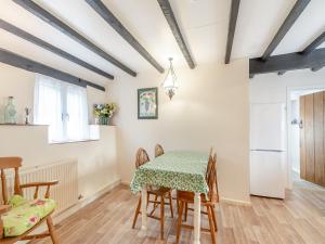 a dining room with a table and chairs at Granary Cottage-uk45587 in Verwick