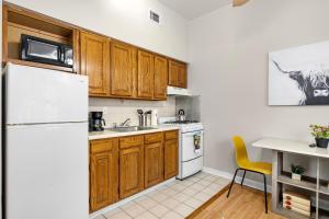 a kitchen with wooden cabinets and a white refrigerator at Boutique 1br With Charm And Style in Philadelphia
