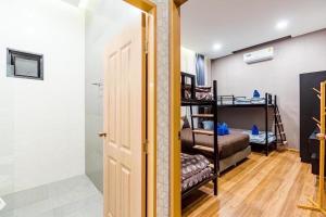 Pokój z 2 łóżkami piętrowymi i drzwiami w obiekcie White Cloud Luxury Pool Villa Cha Am w mieście Cha Am