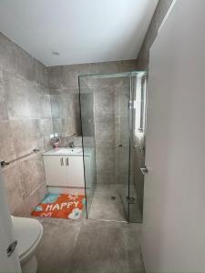 a bathroom with a shower and a toilet and a sink at Brand new comfortable room in a beautiful suburb in St Albans