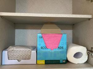 a box and a roll of toilet paper on a shelf at Sarangchae Yeonsu 2 in Incheon