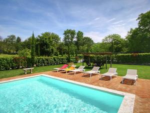 a swimming pool with chairs and a gazebo at Luxurious apartment in Lucignano with views in Lucignano