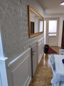 a hallway with a mirror and a white door at Bed & Breakfast - Day Use one in Polla