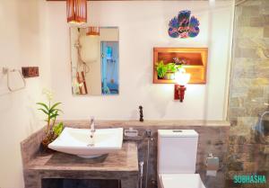 a bathroom with a sink and a toilet and a mirror at Subhasha Summer House in Talalla South +58 photos