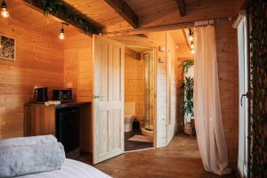 a bedroom with a door leading to a bathroom at Summerhouse @ 73 (Forest of Dean) Gloucestershire in Coleford