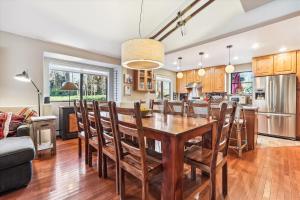 a kitchen and living room with a wooden table and chairs at Park Forest Estates in Breckenridge