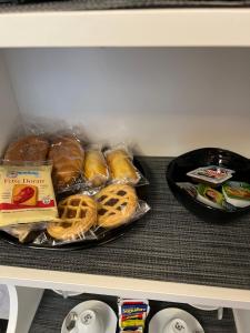a shelf with a bunch of pastries in a refrigerator at Luna Luxury Bed and Breakfast in Naples