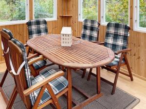 a wooden table and chairs in a room at 6 person holiday home in ASARUM-By Traum in Asarum