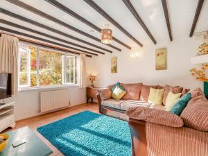 a living room with a couch and a tv at Dairy Cottage-uk45593 in Verwick