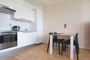 a kitchen with a table and chairs in a room at After Six Apartment in Bratislava