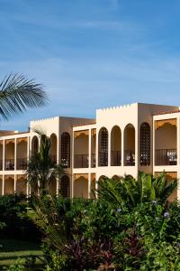馬特姆維的住宿－The Mora Zanzibar，前面有树木的白色大建筑