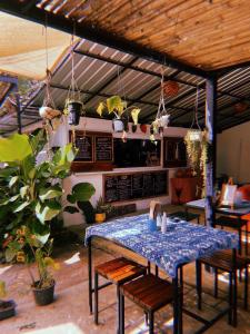 a table and chairs in a room with a kitchen at Tropical Hostel in Ko Phayam +25 photos
