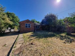 a brick house on a street with a yard at Close to nature, close to city in Kingston 