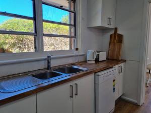 a kitchen with a sink and a window at Close to nature, close to city in Kingston 