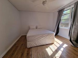 a bedroom with a bed in a room with a window at Close to nature, close to city in Kingston 