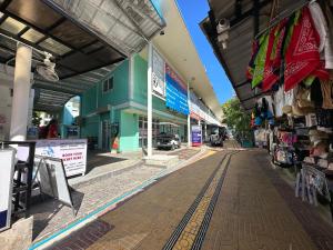 an empty street in a shopping center with stores at Blue Flow Hostel in Phi Phi Don